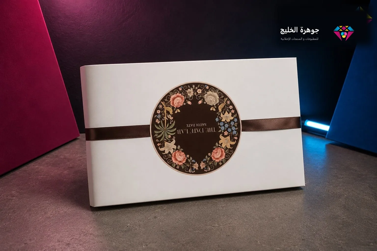 علبة هدايا بيضاء بشريط ساتان وختم دائري مطبوع